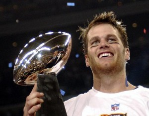 Patriots Quarterback Tom Brady is smiling victorious.