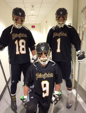 AIC men's lacrosse team members suit up.