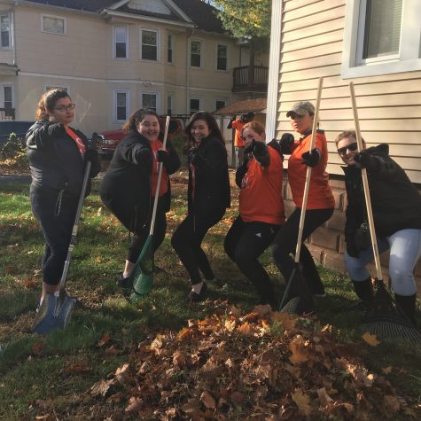 SGA members participate in Action in the Community day raking leaves in neighboring yards.