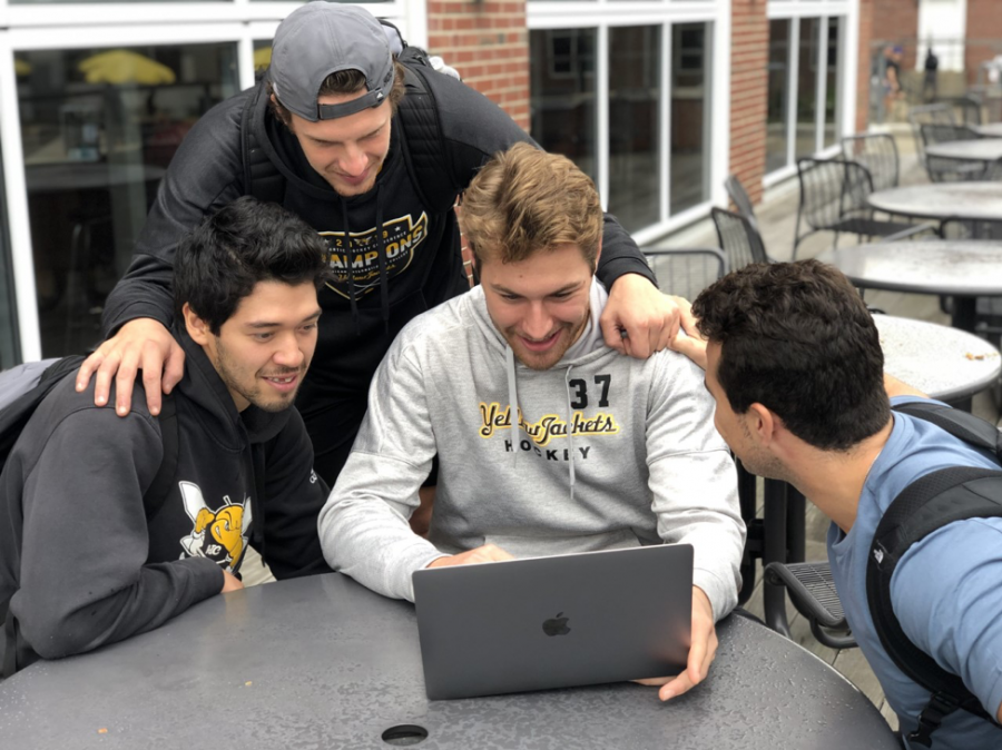 Members of the AIC Hockey Team chatting while enjoying the music outside the Hive