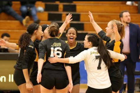 The Yellow Jackets celebrate after winning another set.