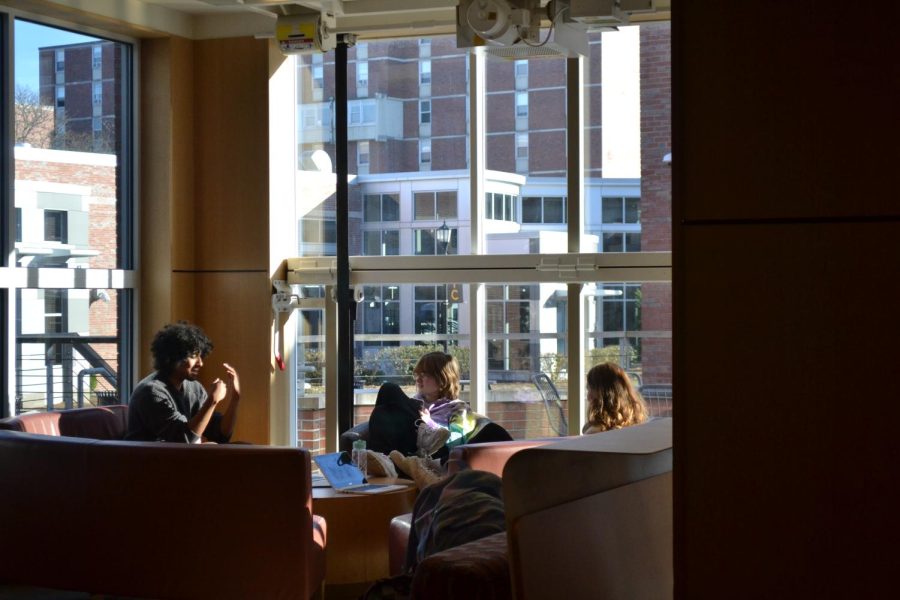 Students studying in The Hive across from Starbucks on campus.