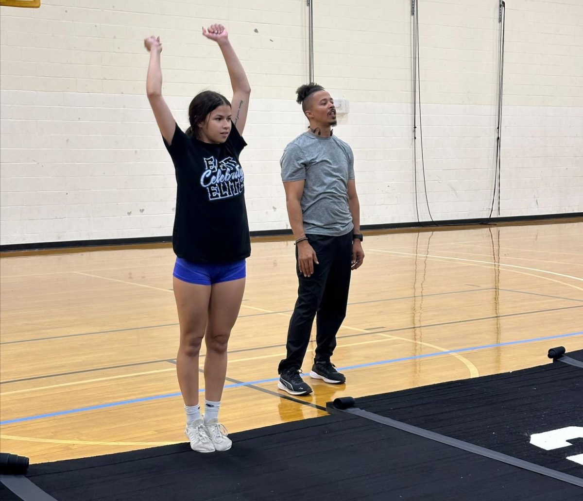 Esperanza Rivera gets ready to tumble with Patrick coaching.